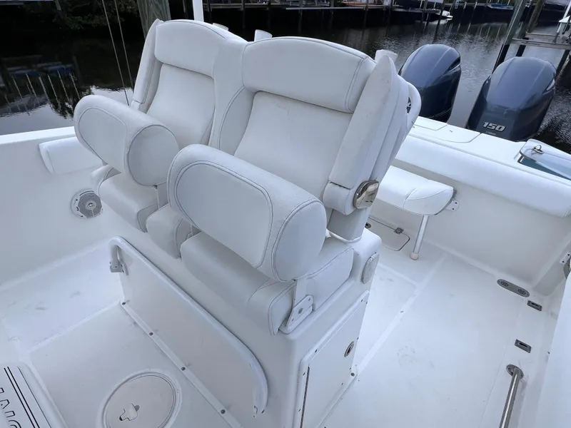 Slide: The Image of 2017 Sea Hunt Gamefish 25 boat interior with dual seats and twin engines. - 18