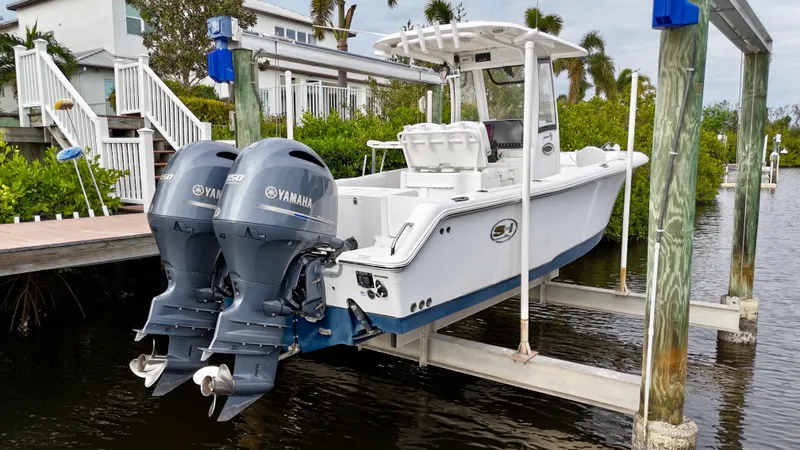 Slide: The Image of 2017 Sea Hunt Gamefish 25 with dual Yamaha engines, docked and well-maintained. - 2