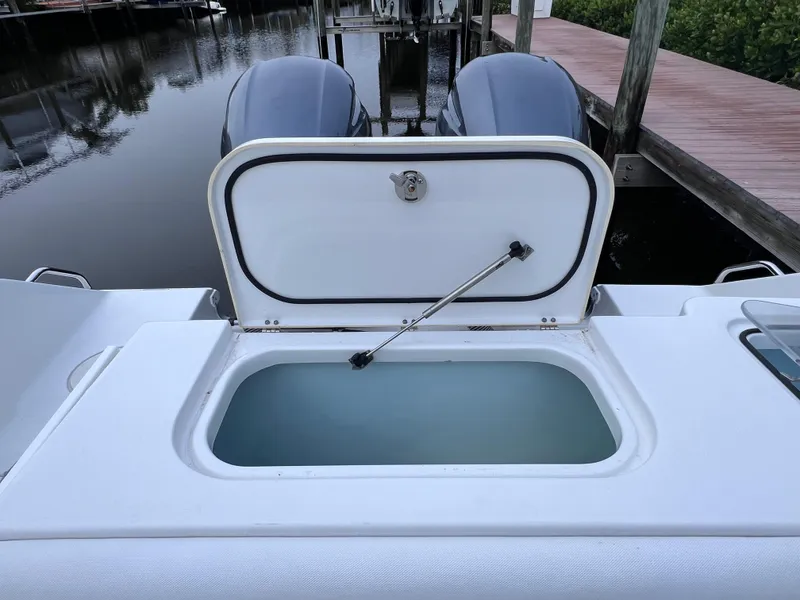 Slide: The Image of 2017 Sea Hunt Gamefish 25 livewell, clean condition, docked with twin engines. - 21