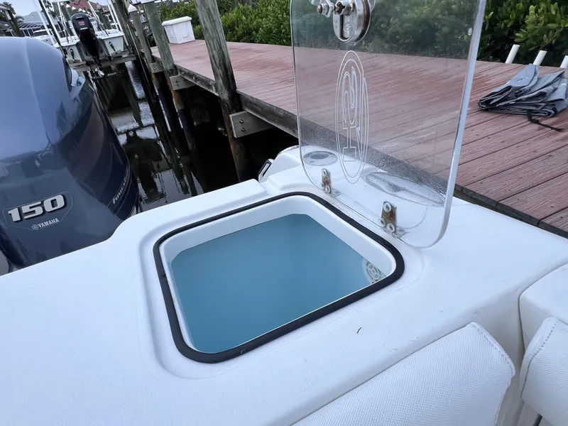 Slide: The Image of 2017 Sea Hunt Gamefish 25 boat with Yamaha 150 engine, docked, featuring a clean livewell. - 22