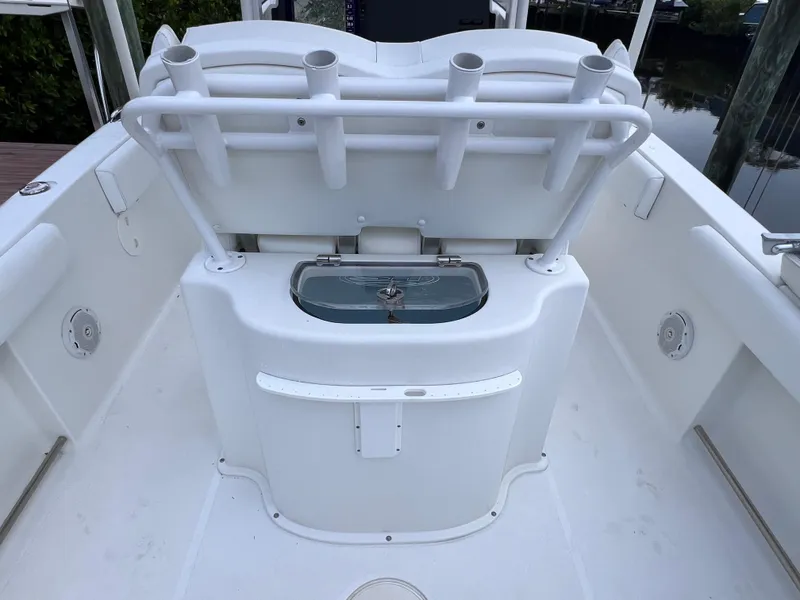 Slide: The Image of 2017 Sea Hunt Gamefish 25 boat interior with rod holders and storage compartment. - 24