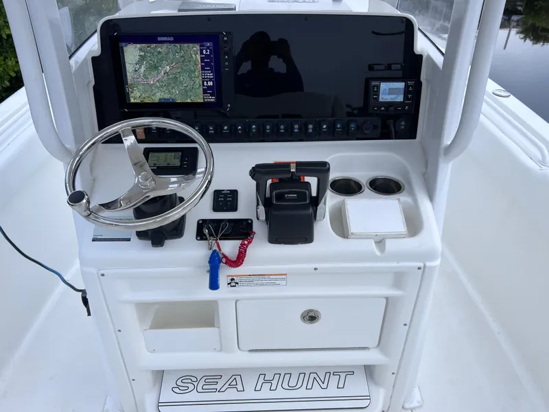 Slide: The Image of 2017 Sea Hunt Gamefish 25 boat console with navigation system and controls. - 25