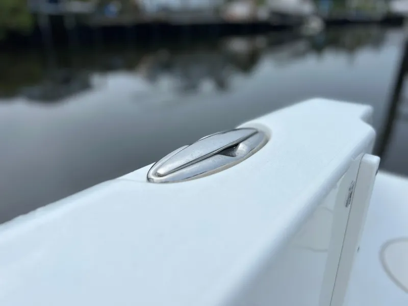 Slide: The Image of Close-up of a 2017 Sea Hunt Gamefish 25 boat cleat by the water. - 26