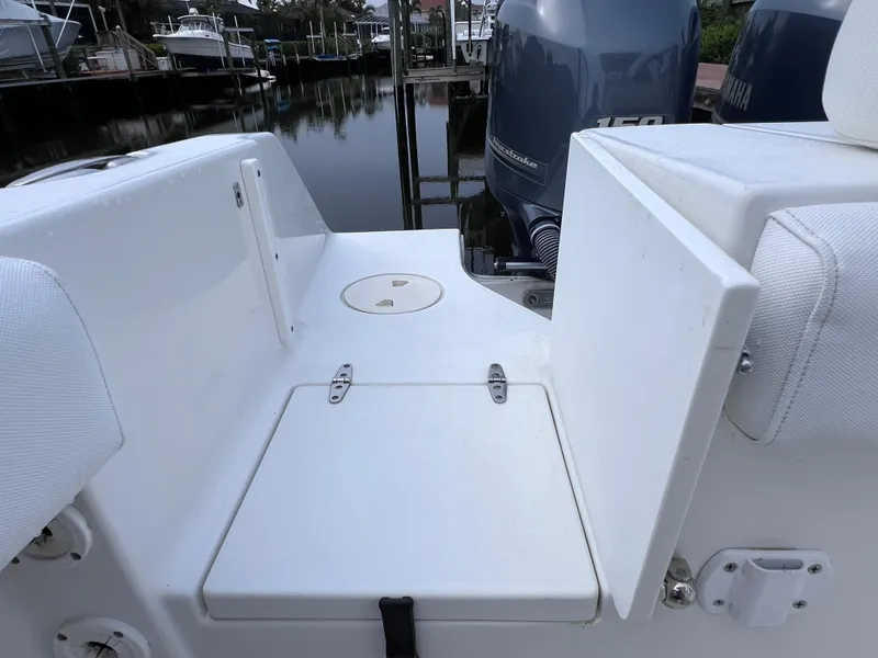 Slide: The Image of 2017 Sea Hunt Gamefish 25 boat, clean deck, dual outboard motors, marina background. - 28