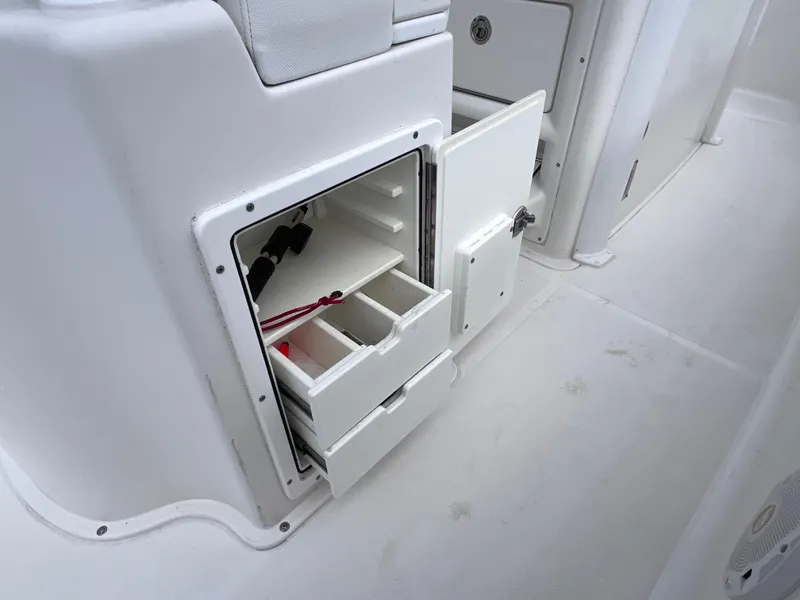 Slide: The Image of 2017 Sea Hunt Gamefish 25 storage compartment with open drawers and door. - 30