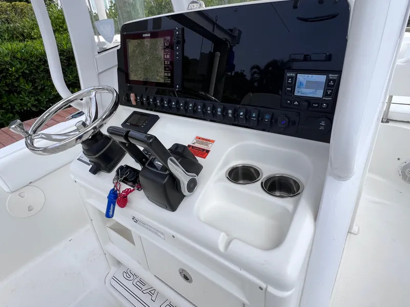 Slide: The Image of 2017 Sea Hunt Gamefish 25 helm with modern controls and navigation system. - 31