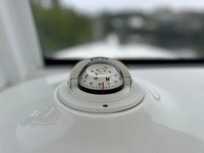 Slide: The Image of Compass on 2017 Sea Hunt Gamefish 25 boat dashboard, close-up view. - 35