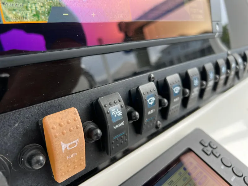 Slide: The Image of Close-up of 2017 Sea Hunt Gamefish 25 control panel with navigation switches. - 38