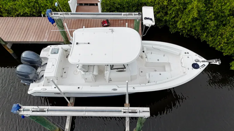 Slide: The Image of 2017 Sea Hunt Gamefish 25 boat, clean condition, docked with dual engines, aerial view. - 4
