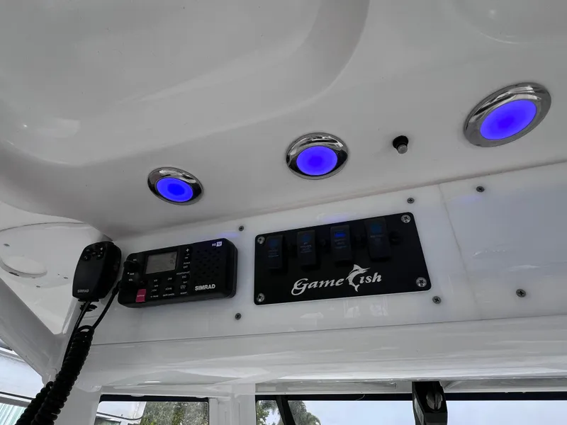 Slide: The Image of 2017 Sea Hunt Gamefish 25 interior with blue LED lights and control panel. - 43