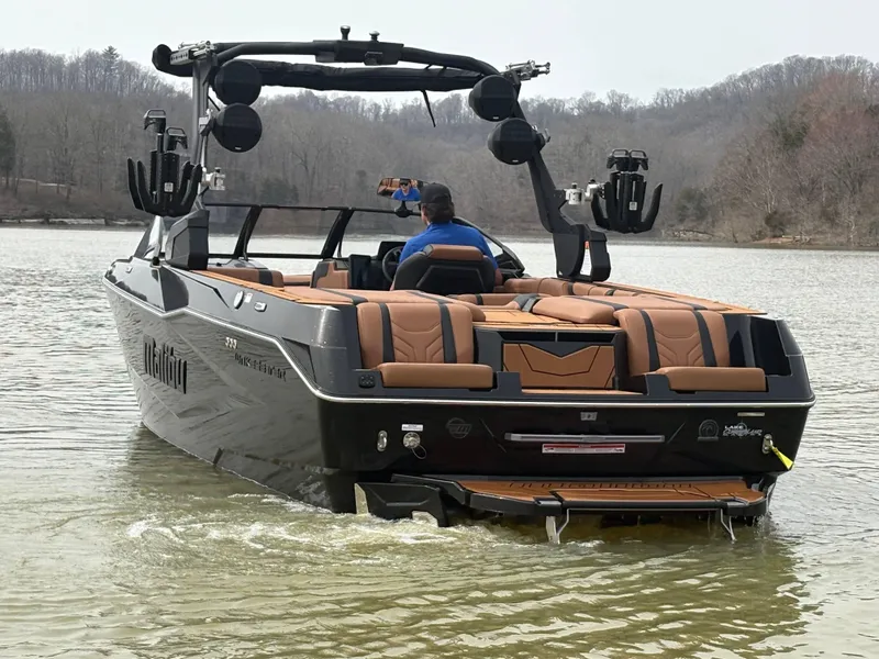 Slide: The Image of 2025 Malibu 25 LSV boat on a lake, featuring luxurious seating and advanced wakeboard tower. - 11