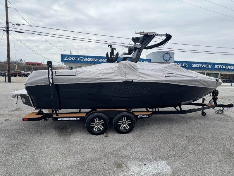 Slide: The Image of 2025 Malibu 25 LSV boat covered on trailer at Lake Cumberland Marine. - 29