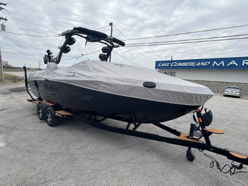 Slide: The Image of 2025 Malibu 25 LSV boat covered, parked at Lake Cumberland Marina. - 32