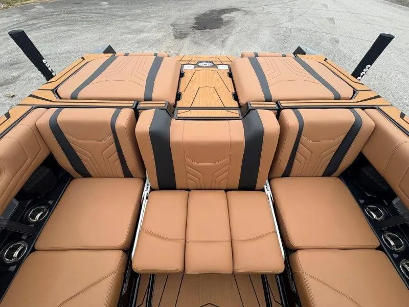 Slide: The Image of 2025 Malibu 25 LSV boat interior with tan and black seating, showcasing luxury design. - 33