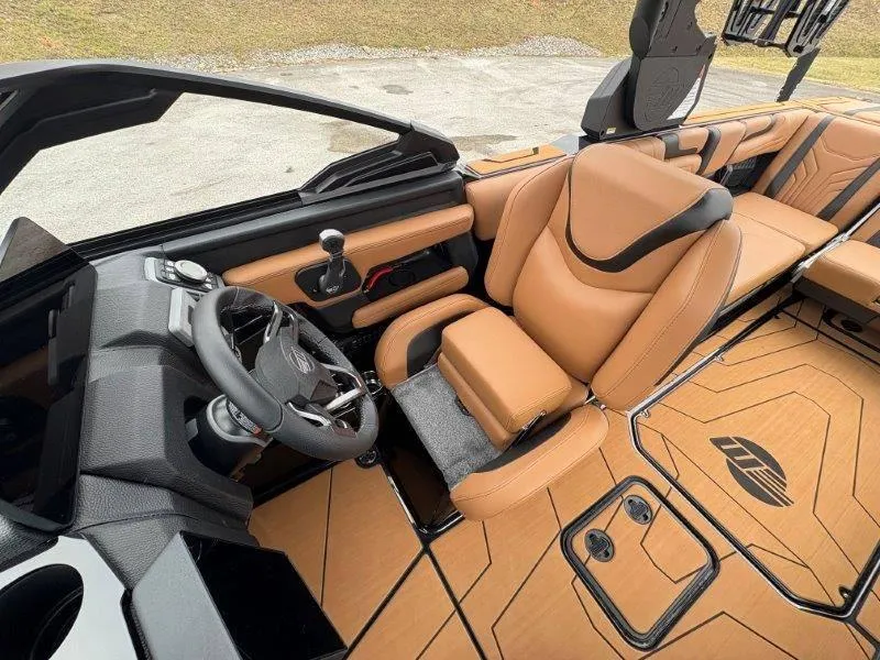 Slide: The Image of Luxurious interior of 2025 Malibu 25 LSV boat with tan leather seats and modern dashboard. - 44