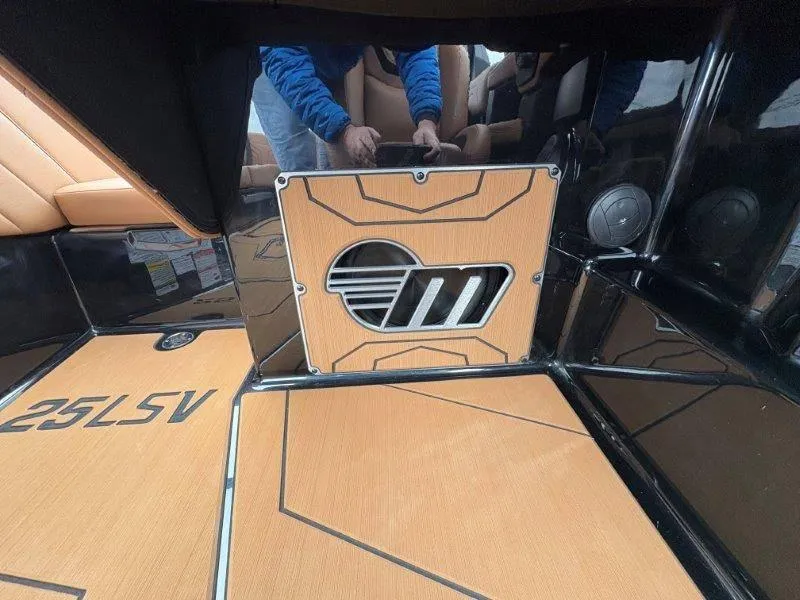 Slide: The Image of 2025 Malibu 25 LSV boat interior with custom flooring and sound system. - 45