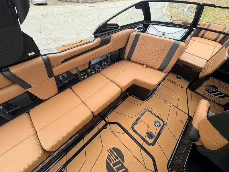 Slide: The Image of 2025 Malibu 25 LSV boat interior with tan leather seating and sleek design. - 46