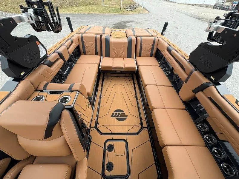 Slide: The Image of Luxurious interior of 2025 Malibu 25 LSV boat with tan leather seating and sleek design. - 48