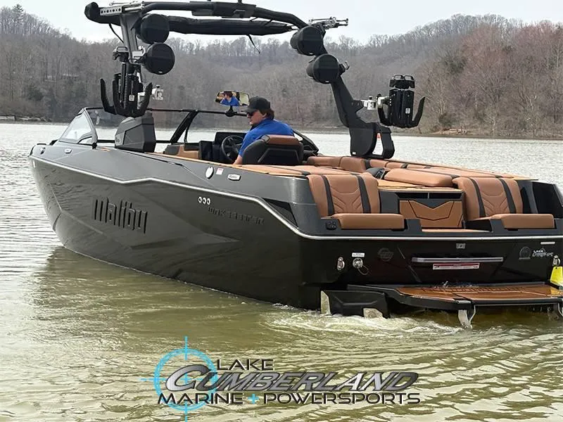 Slide: The Image of 2025 Malibu 25 LSV boat on a lake, featuring sleek design and luxury seating. - 5