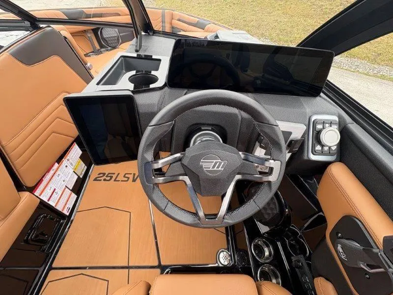 Slide: The Image of 2025 Malibu 25 LSV boat interior with modern dashboard and steering wheel design. - 51