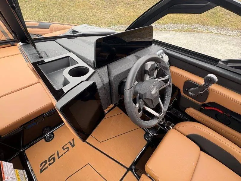 Slide: The Image of 2025 Malibu 25 LSV boat interior with modern dashboard and steering wheel design. - 53
