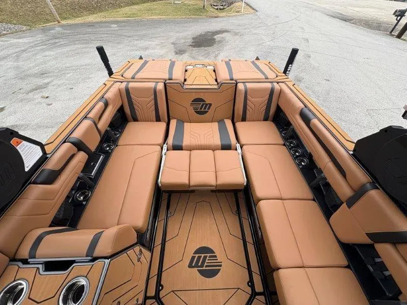 Slide: The Image of 2025 Malibu 25 LSV boat interior with tan leather seating and stylish design. - 56