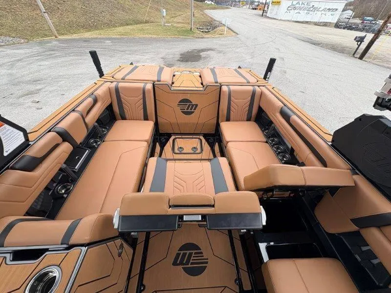 Slide: The Image of 2025 Malibu 25 LSV boat interior with tan and black seating, showcasing luxury and comfort. - 60