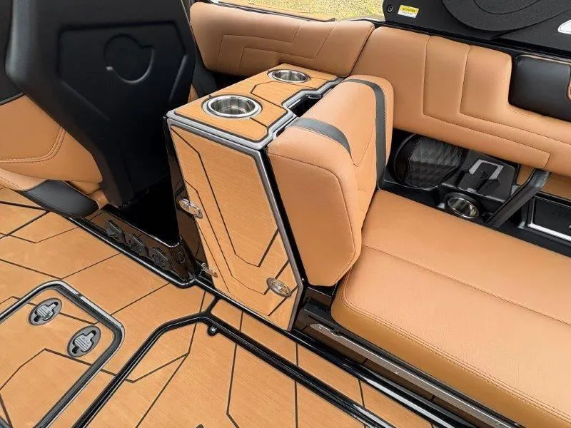 Slide: The Image of 2025 Malibu 25 LSV interior with tan leather seats and cup holders. - 62