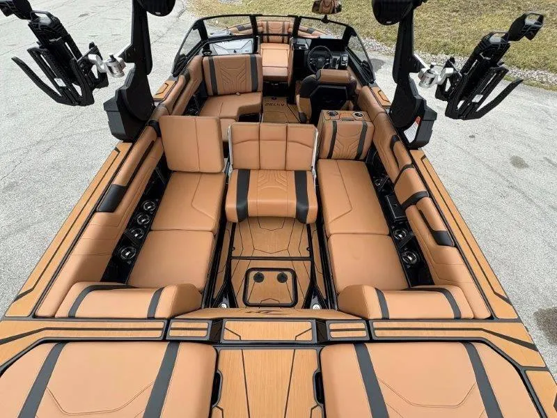 Slide: The Image of 2025 Malibu 25 LSV boat interior with luxurious tan seating and modern design. - 64