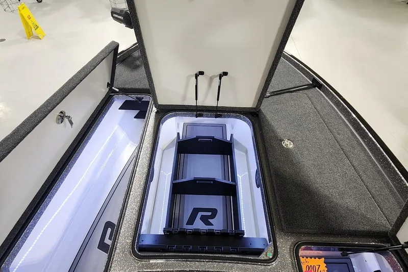 Slide: The Image of 2025 Ranger Z520R Cup-Equipped boat storage compartment with open lid and organized interior. - 12