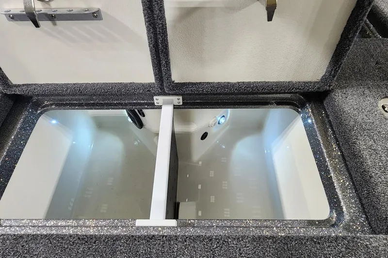 Slide: The Image of 2025 Ranger Z520R Cup-Equipped boat storage compartment with LED lighting and carpeted interior. - 15