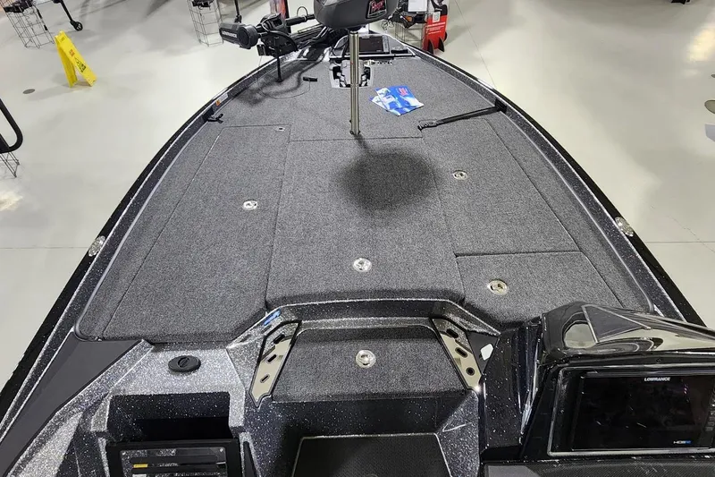 Slide: The Image of 2025 Ranger Z520R Cup-Equipped boat deck with carpeted surface and fishing equipment. - 5