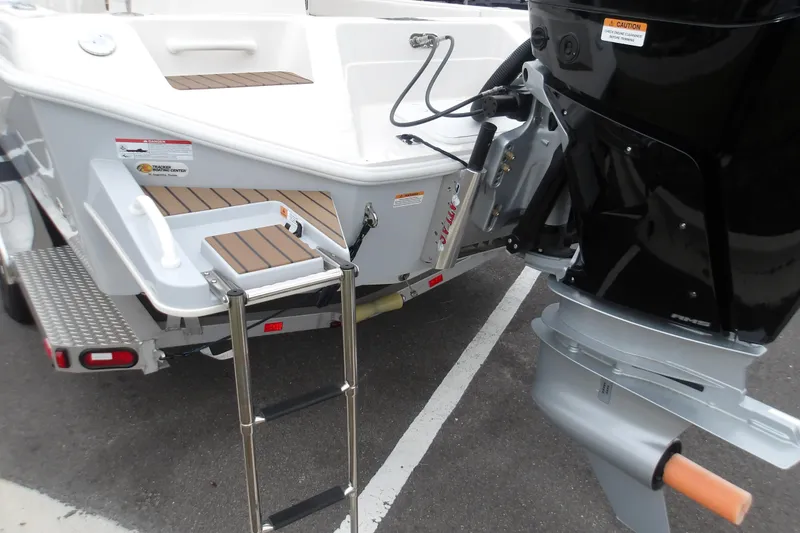 Slide: The Image of 2025 Ranger 2660 Bay boat stern with motor and boarding ladder. - 11