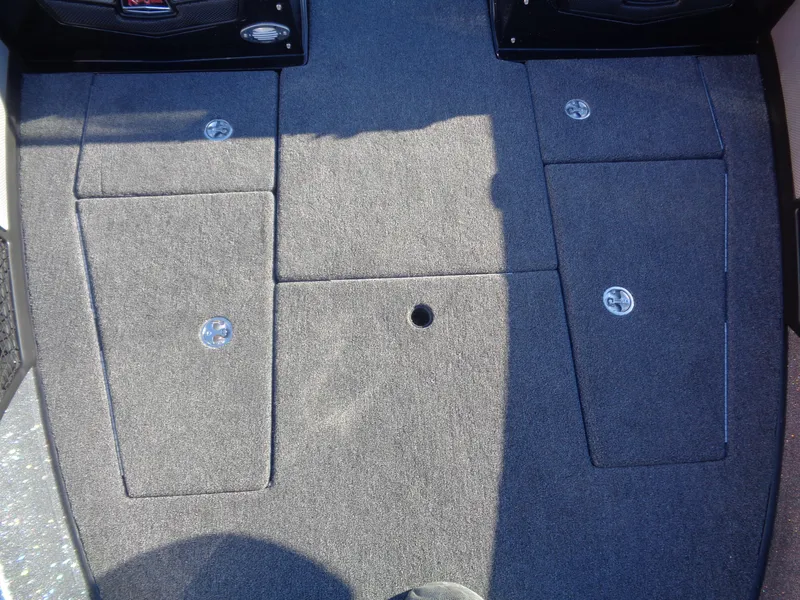 Slide: The Image of Interior view of 2025 Ranger 1880MS boat with carpeted flooring and storage compartments. - 11