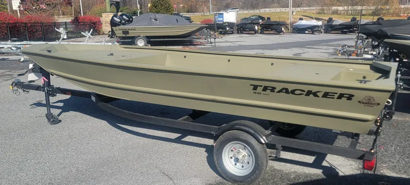 Slide: The Image of 2025 Tracker Grizzly 1648 Jon boat on trailer in outdoor setting. - 16