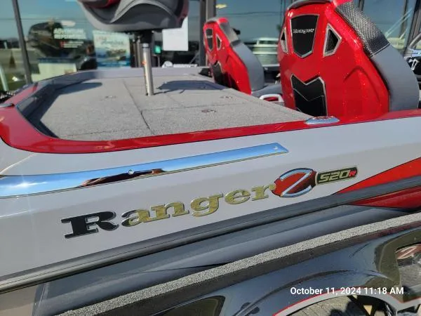 Slide: The Image of 2025 Ranger Z520R Cup-Equipped boat with red accents and seating, photographed outdoors. - 2