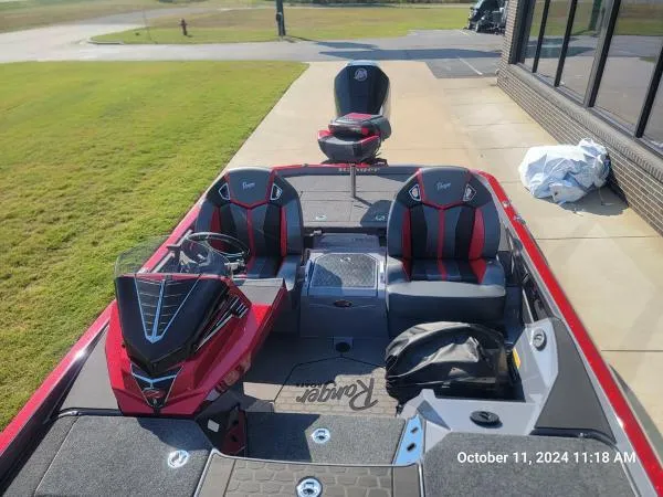Slide: The Image of 2025 Ranger Z520R Cup-Equipped boat with red and black seating, docked outdoors. - 4
