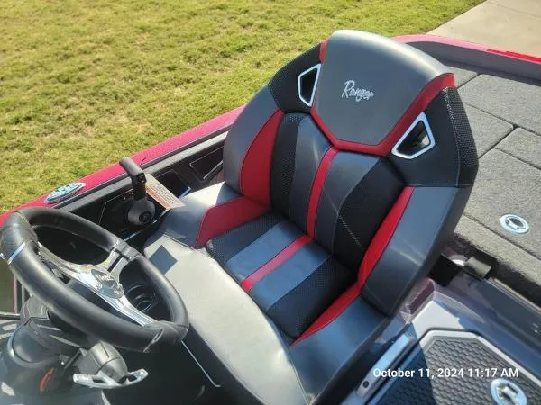 Slide: The Image of 2025 Ranger Z520R Cup-Equipped boat seat with red and black design, steering wheel visible. - 9