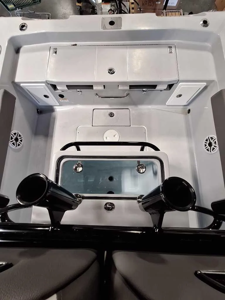 Slide: The Image of 2025 Ranger 2660 Bay boat interior with storage compartments and rod holders. - 3