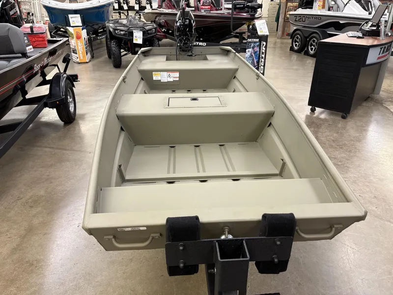 Slide: The Image of 2025 Tracker Grizzly 1542 Utility boat displayed in showroom, featuring spacious interior and durable design. - 2