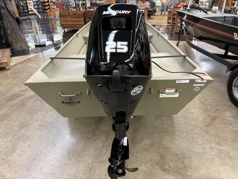 Slide: The Image of 2025 Tracker Grizzly 1542 Utility boat with Mercury 25 outboard motor displayed indoors. - 5