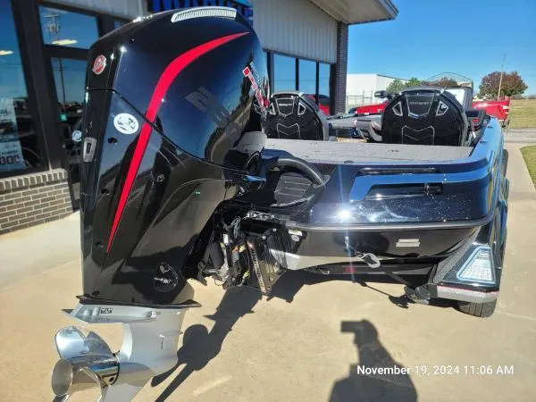 Slide: The Image of 2025 Ranger Z520R Cup-Equipped boat with powerful outboard motor, parked outside a building. - 2