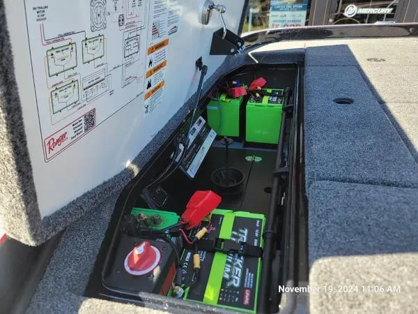 Slide: The Image of 2025 Ranger Z520R Cup-Equipped boat battery compartment with green batteries and wiring. - 5