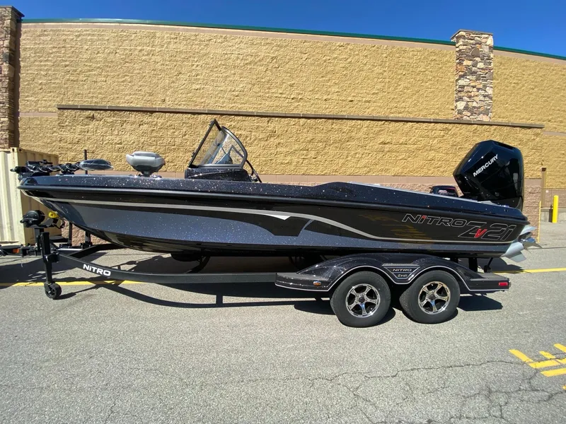 Slide: The Image of 2025 Nitro ZV21 Pro boat on trailer, parked outdoors, side view. - 2