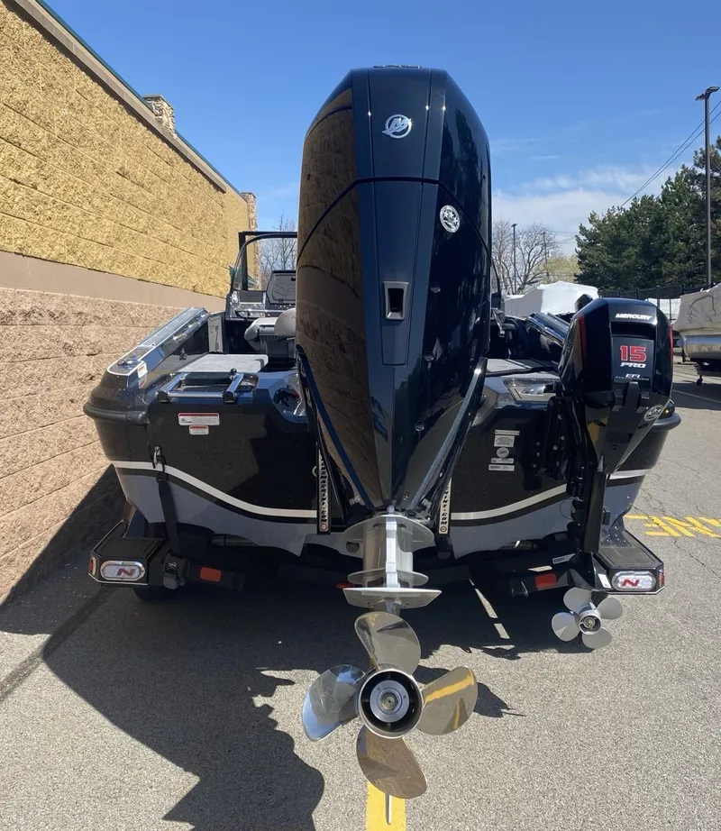 Slide: The Image of 2025 Nitro ZV21 Pro boat with dual outboard motors, parked outdoors. - 4