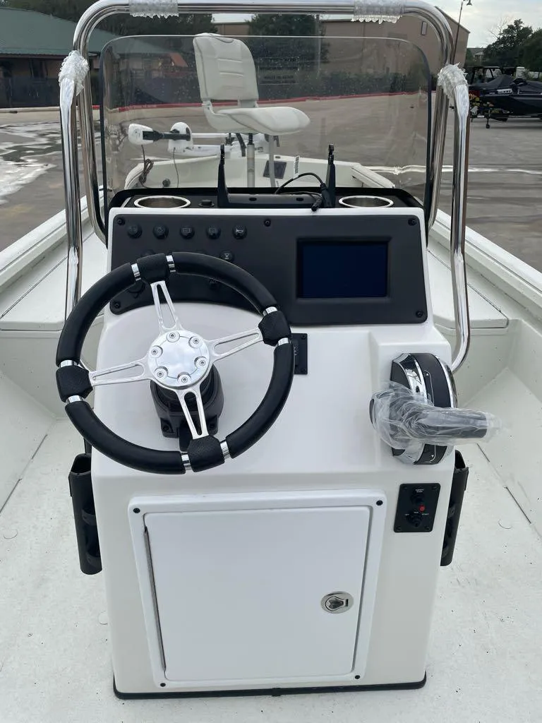 Slide: The Image of 2025 Ranger RB210 boat console with steering wheel and navigation display. - 6