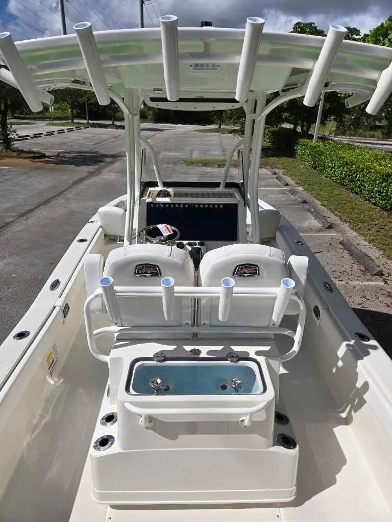 Slide: The Image of 2025 Ranger 2660 Bay boat interior with rod holders and seating. - 2