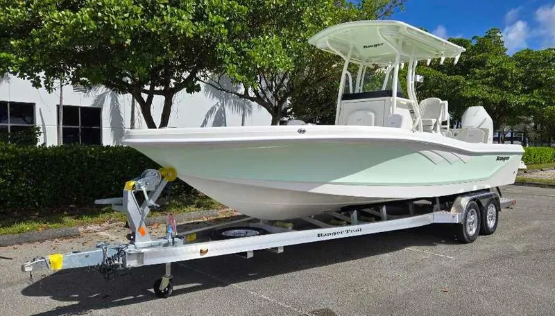 Slide: The Image of 2025 Ranger 2660 Bay boat on trailer, parked outdoors. - 4
