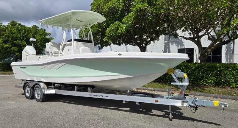 Slide: The Image of 2025 Ranger 2660 Bay boat on trailer, parked outdoors. - 5