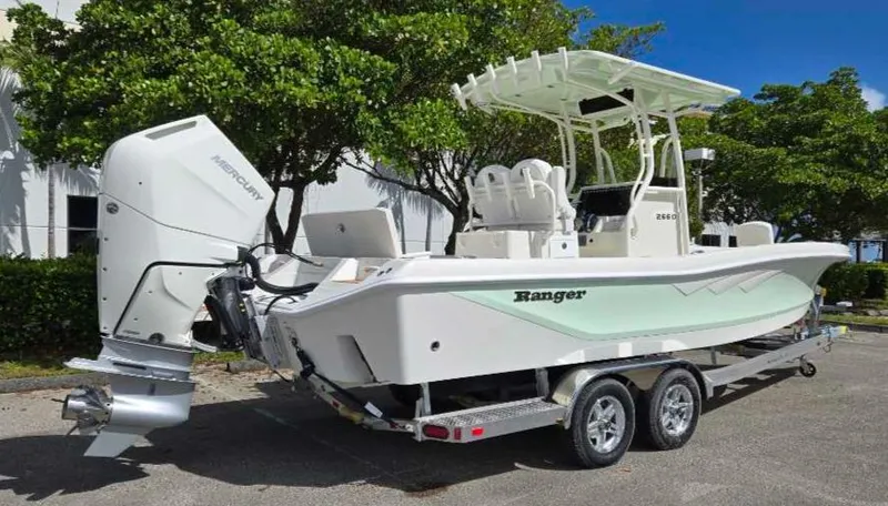 Slide: The Image of 2025 Ranger 2660 Bay boat on trailer, parked outdoors. - 6